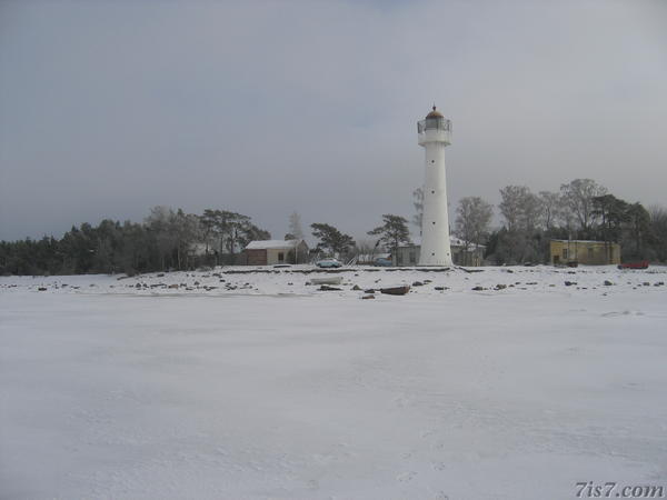 Saxby Lighthouse seen from the frozen sea.
