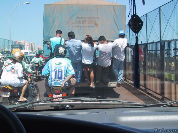 Pedestrians Hanging on Truck