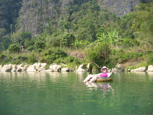 Maris floating down the river Song on an inner tube. Vang Vieng, Laos.